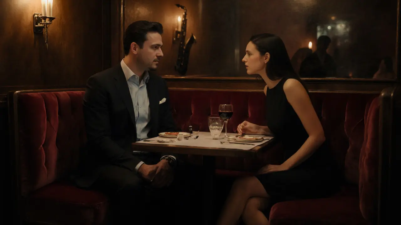 Couple sharing wine at an intimate bistro booth, elegant outfits.